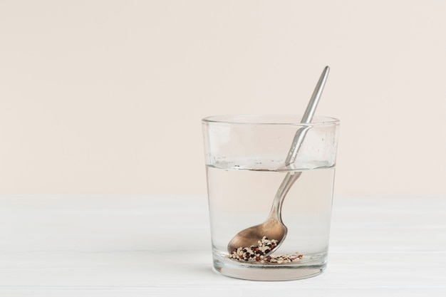 Free photo arrangement with glass of water with seeds