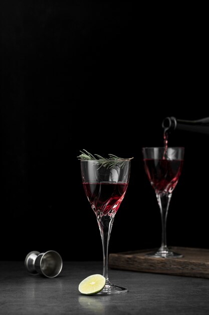 Arrangement with glasses of drink and dark background