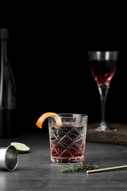 Arrangement with glasses of drink and orange slice