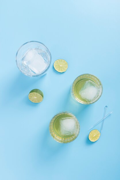 Arrangement with glasses of lemonade and ice cubes