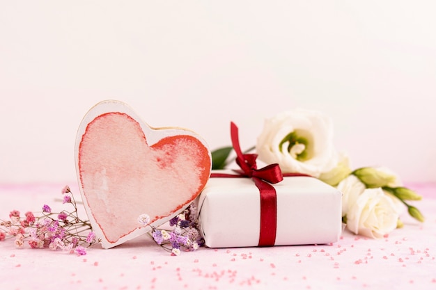 Arrangement with heart shaped cookie and present