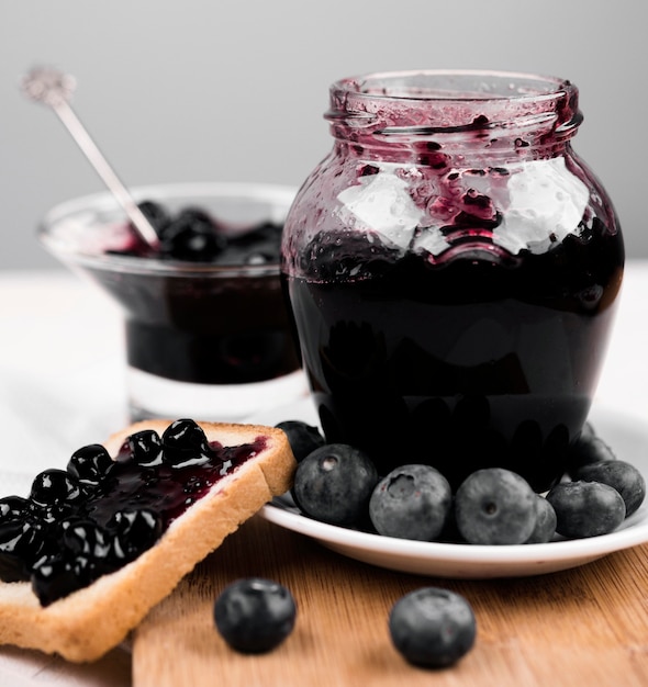 Free photo arrangement with jar of blueberry jam