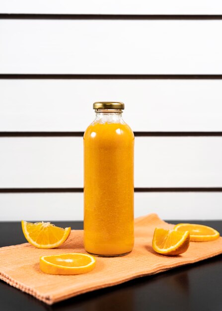 Arrangement with juice bottle and fruits