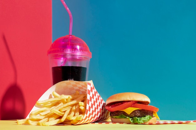 Arrangement with juice cup and delicious burger