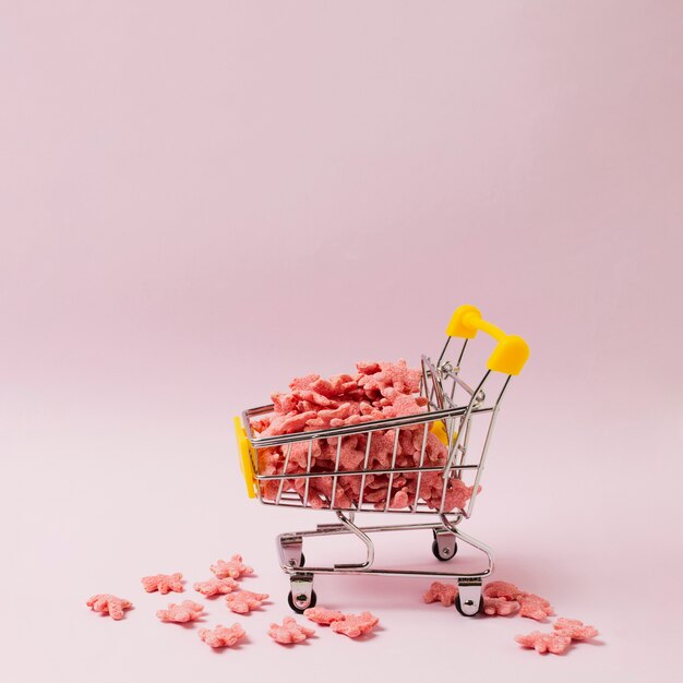 Arrangement with little shopping cart and cereals