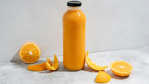 Arrangement with orange juice and fruits