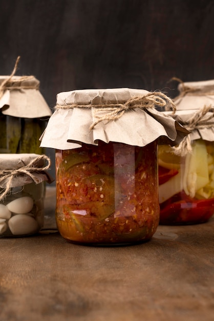 Free photo arrangement with pickled vegetables in jars