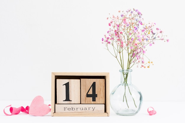 Free photo arrangement with pink ribbon and flower vase