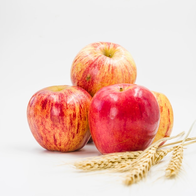 Arrangement with red apples and wheat ears