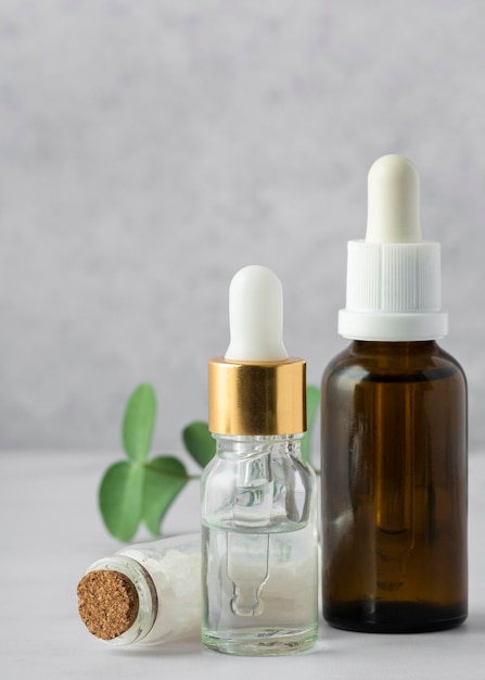 Free photo arrangement with serum bottles and salts
