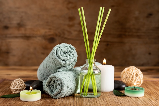 Arrangement with spa scented sticks and towels
