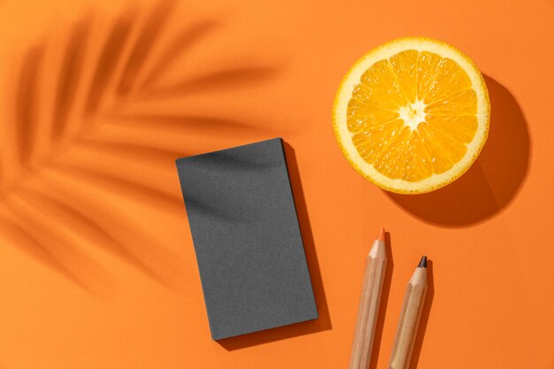 Arrangement with stationery elements and orange