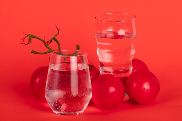 Arrangement with tomatoes on red background