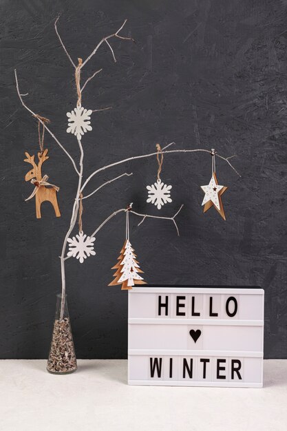 Arrangement with tree and hello winter sign