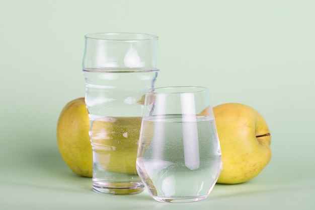 Arrangement with water and yellow apples