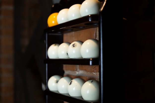 Free photo arrangement with white balls on black shelf