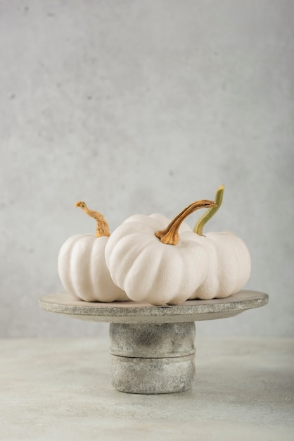 Arrangement with white pumpkins on plate