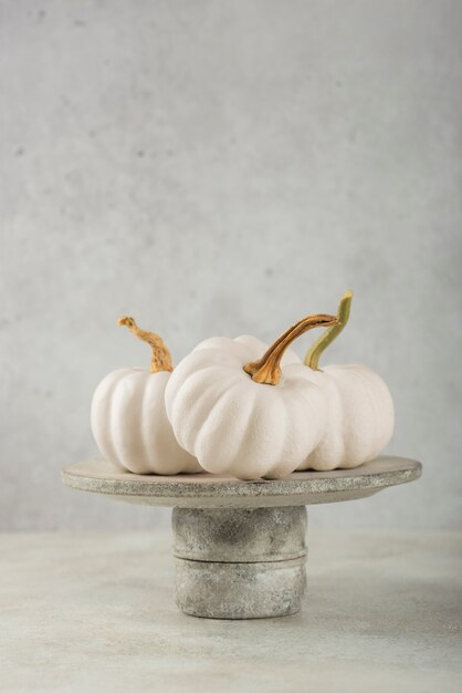 Arrangement with white pumpkins on plate