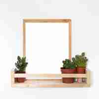 Free photo arrangement of wooden empty frame on table