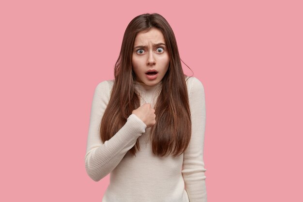 Arrogant annoyed shocked lady points at herself, asks not blame her, surprised to be chosen for participating in meeting, has dark straight hair