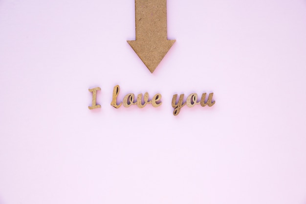 Free photo arrow pointing at elegant i love you writing