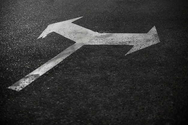 Arrow sign on the road in the city