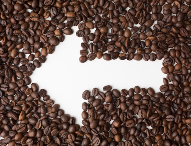 Arrow through coffee beans pointing left