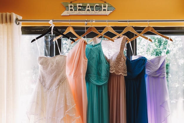 Arrow with lettering 'Beach' hangs over the pastel dresses