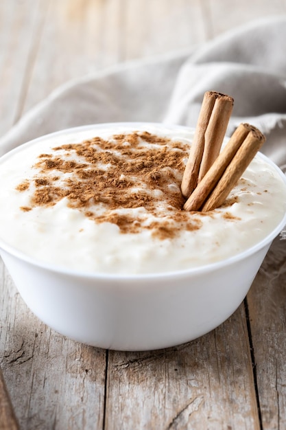 Free photo arroz con leche rice pudding with cinnamon in bowl on wooden table