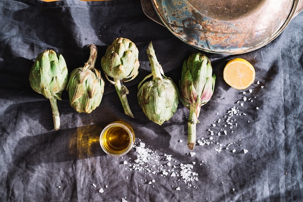 Artichokes near salt and lemon