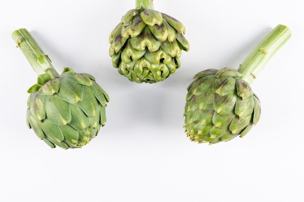 Artichokes on a white . flat lay.