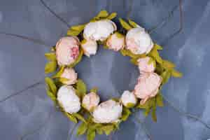 Free photo artificial flower wreath on blue.