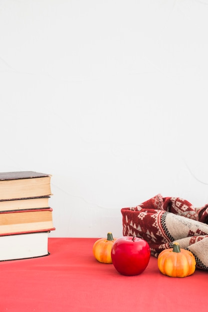 Artificial fruits and blanket near books