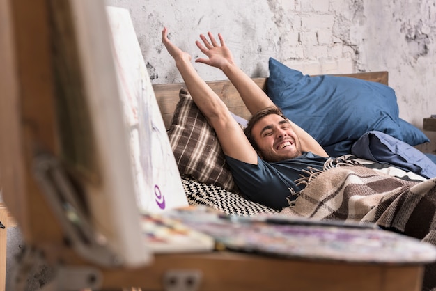 Artist in bed in studio