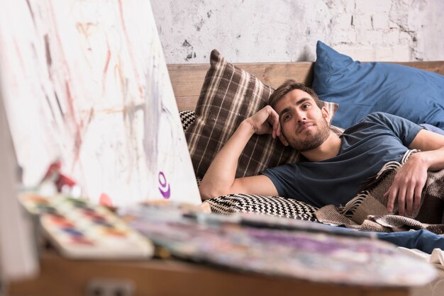 Artist in bed in studio