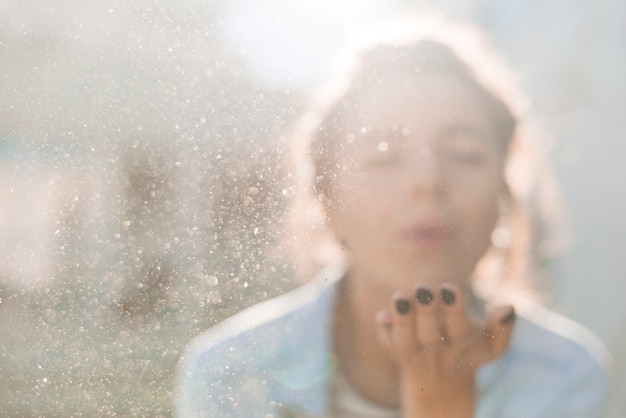 Artist blowing particles