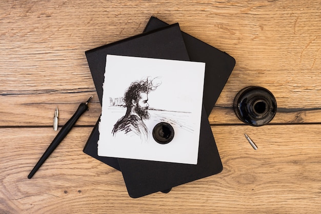 Free photo artist concept with notebook and pencils