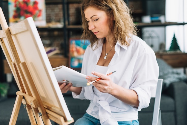 Artist in front of canvas