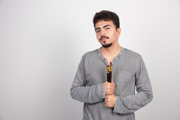 Artist holding his new set of professional painting brushes.