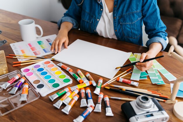 Artist painting at desk