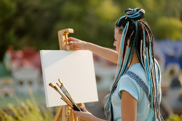 The artist painting outdoors