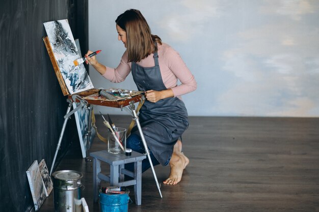 Artist painting in studio