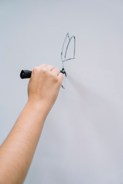 Artist's hand drawing on the whiteboard