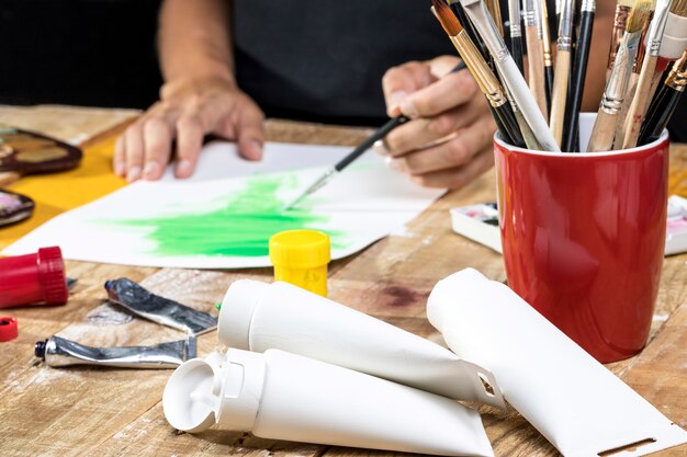 Artist in studio with paint and brushes