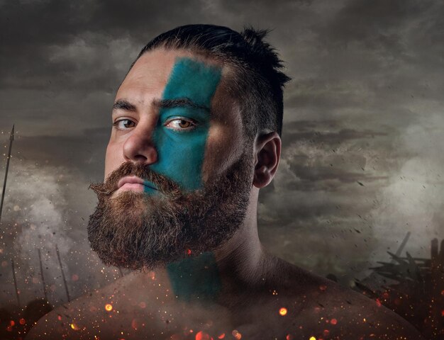 Artistic close up portrait of Scandinavian male warrior on a battlefield.