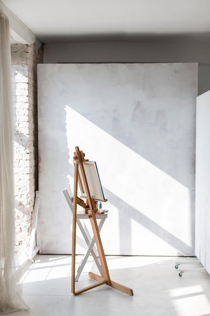 Artistic easel and canvas in studio