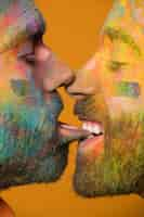 Free photo artistic painted homosexual men kissing in lips