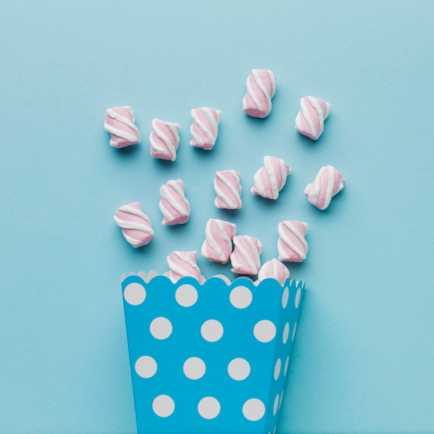 Artistic photo of marshmallows on blue table