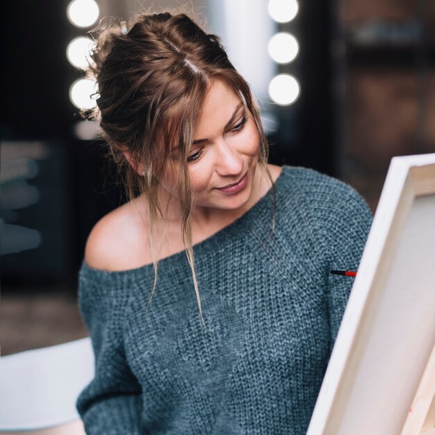 Artistic woman painting on canvas