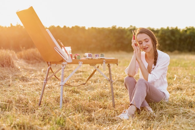 Artistic woman sitting on the grass